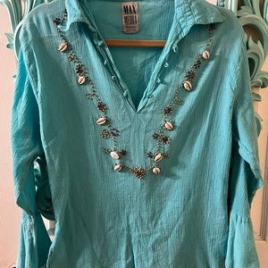 Turquoise beachy top with shell detailing.